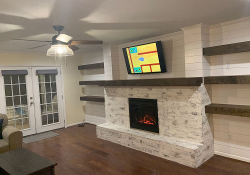 buffalo-home-remodeling-and-remediation-services-living-room-white-stone-fireplace-floating-shelves